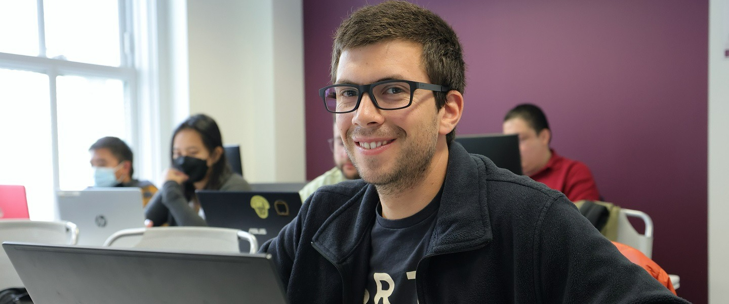 A person posing and smiling for the camera