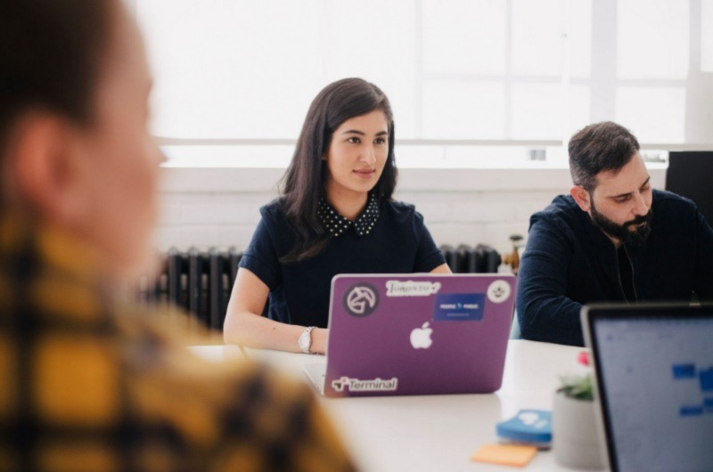 Women and men sitting in a meeting room