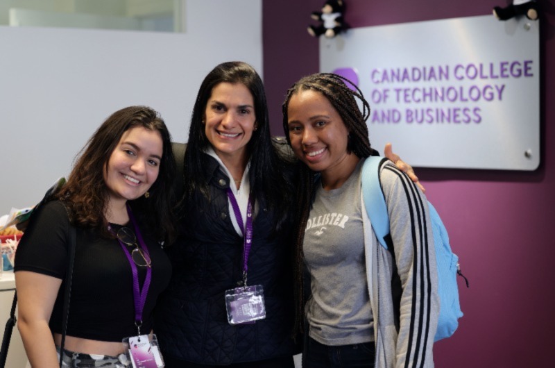 Three Women wearing an ID card and smiling
