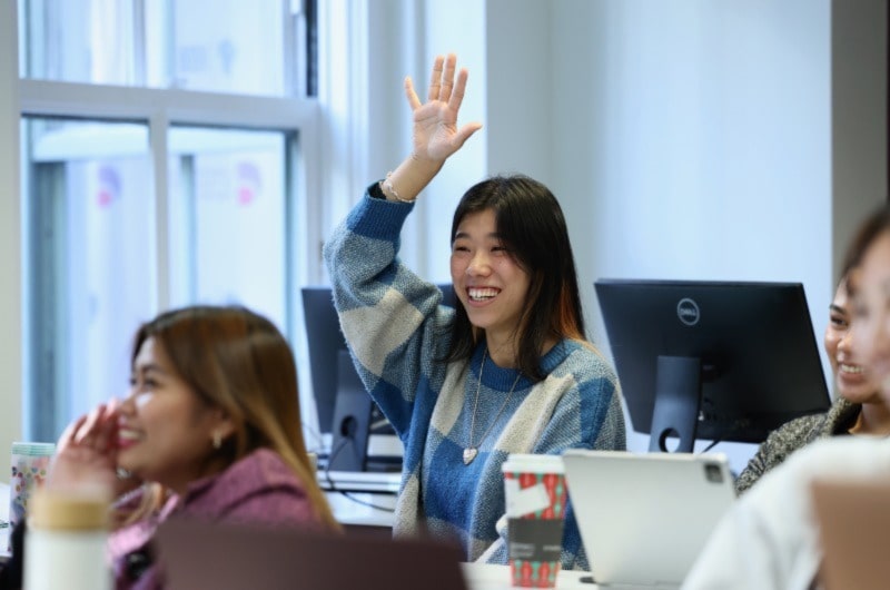 Woman smiling, Raising hand, posing for photo