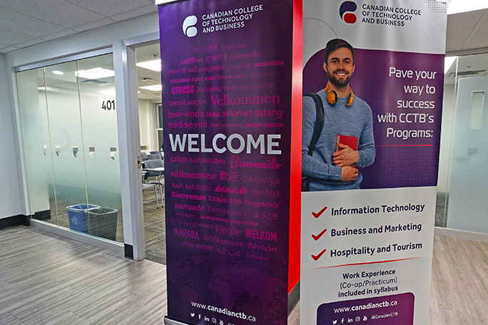 Campus entrance with welcome banner and program information display
